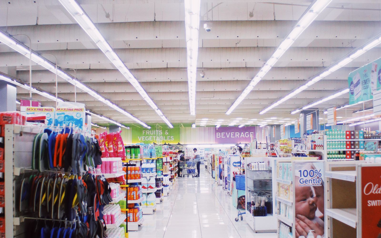 Bright supermarket aisle and stocked shelves